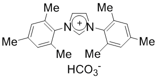 1,3-Bis(2,4,6-trimethylphenyl)imidazolium bicarbonate, min. 97% IMesH.HCO₃